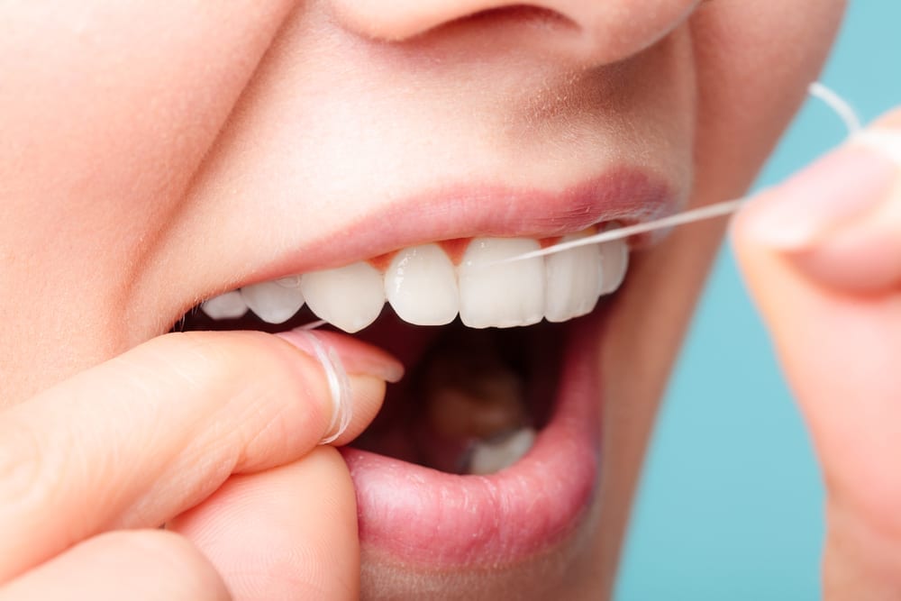 Image of woman flossing